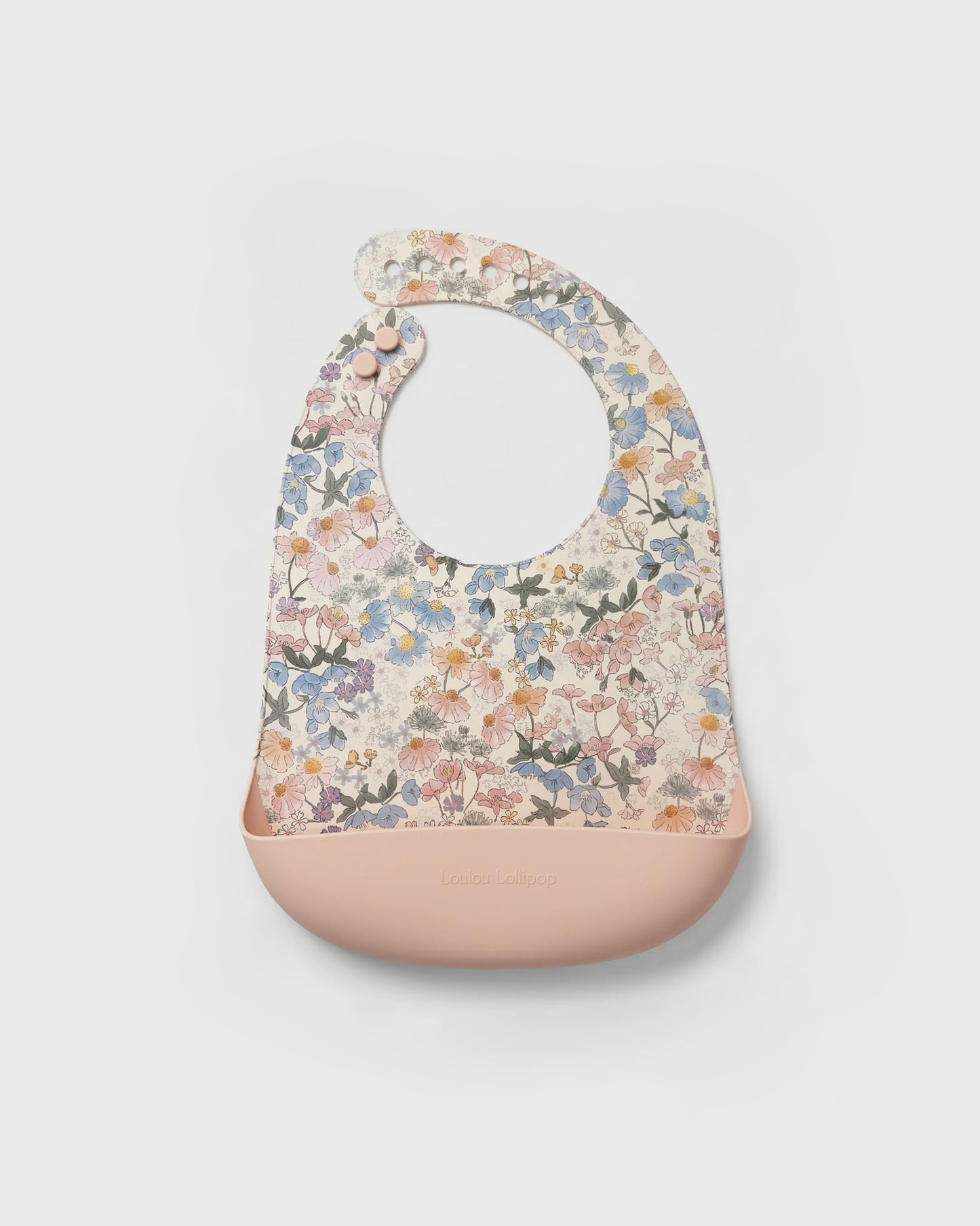 Floral-patterned baby bib with a beige base on a light gray background.