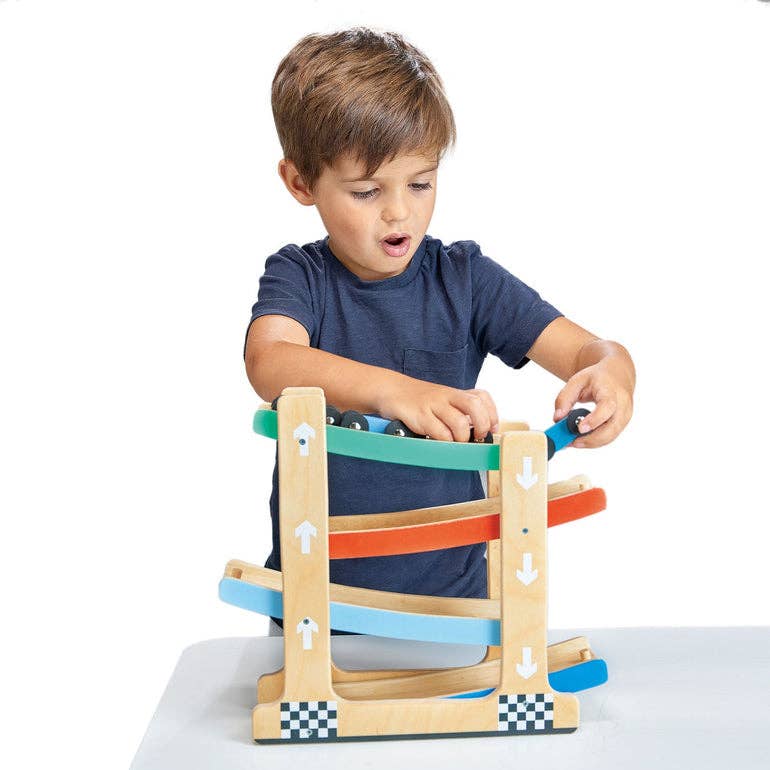 
                  
                    Child playing with a colorful wooden toy on a white background.
                  
                