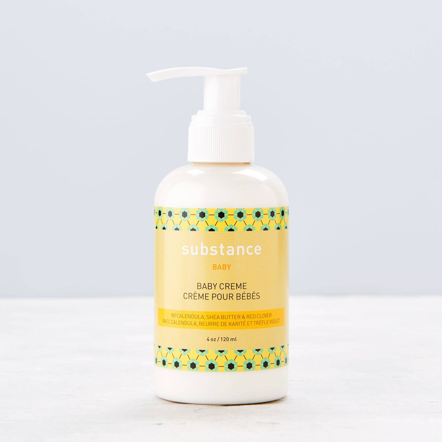 Bottle of 'substance' baby crème with pump on a light gray background