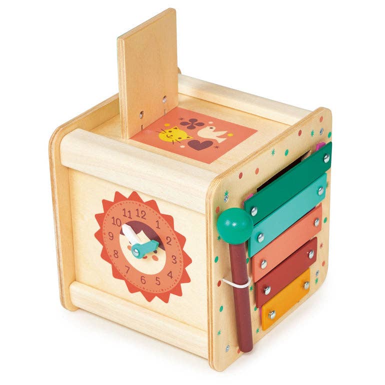 
                  
                    Wooden toy with colorful panels and a clock design on a white background.
                  
                