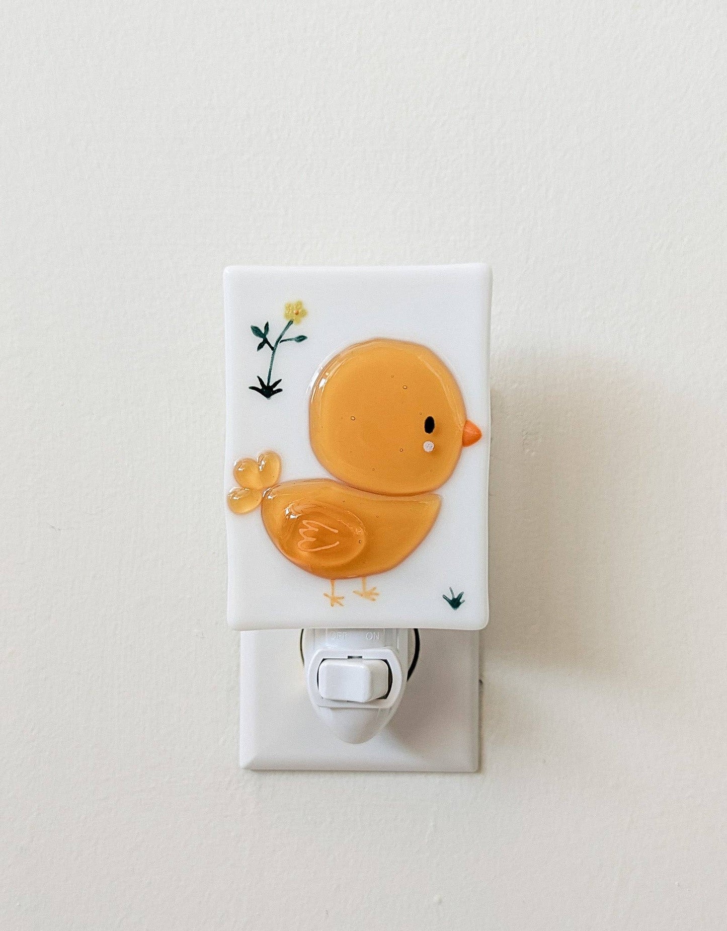 Decorative night light with a cartoon chick design on a white background.