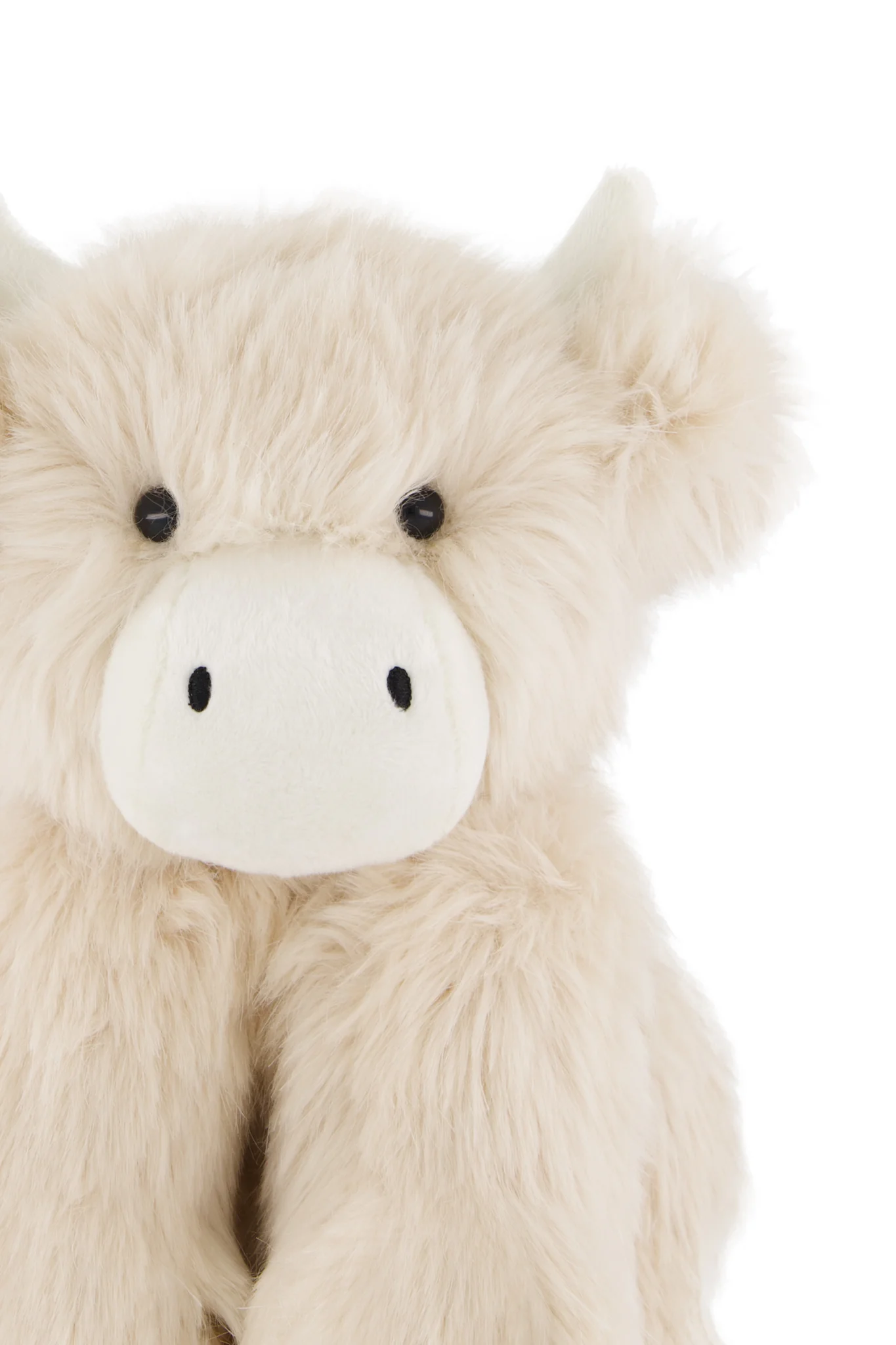 
                  
                    Plush toy cow with a white face and black eyes on a white background.
                  
                