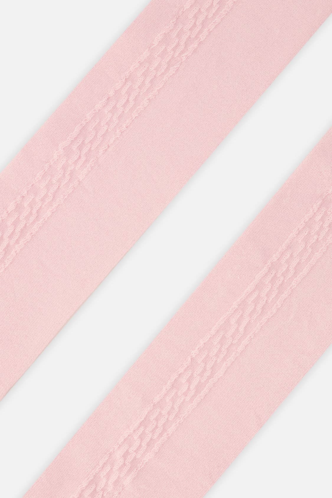 
                  
                    A close-up of light pink tights shown diagonally against a clean white background.
                  
                