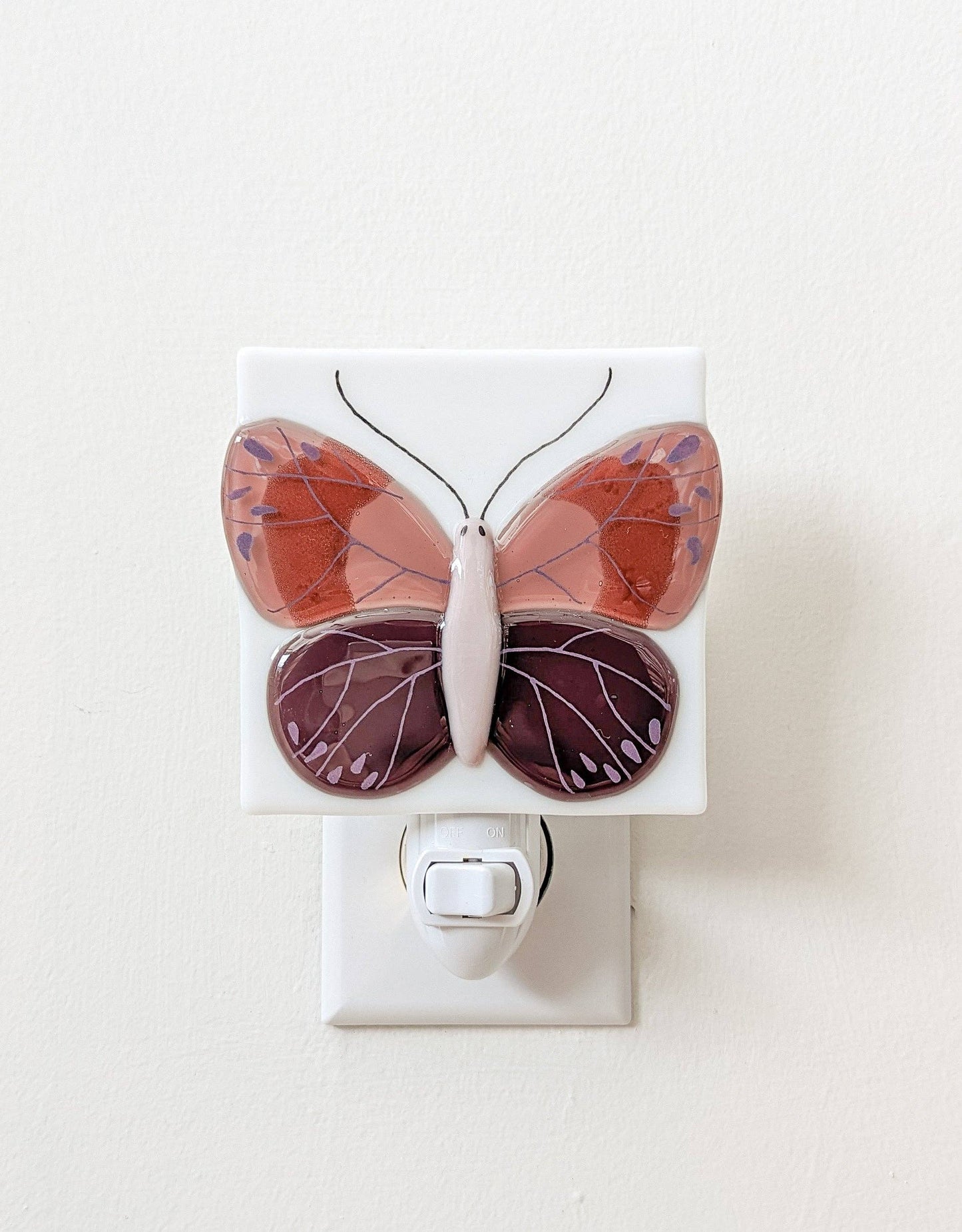 Butterfly-shaped night light on a white background.