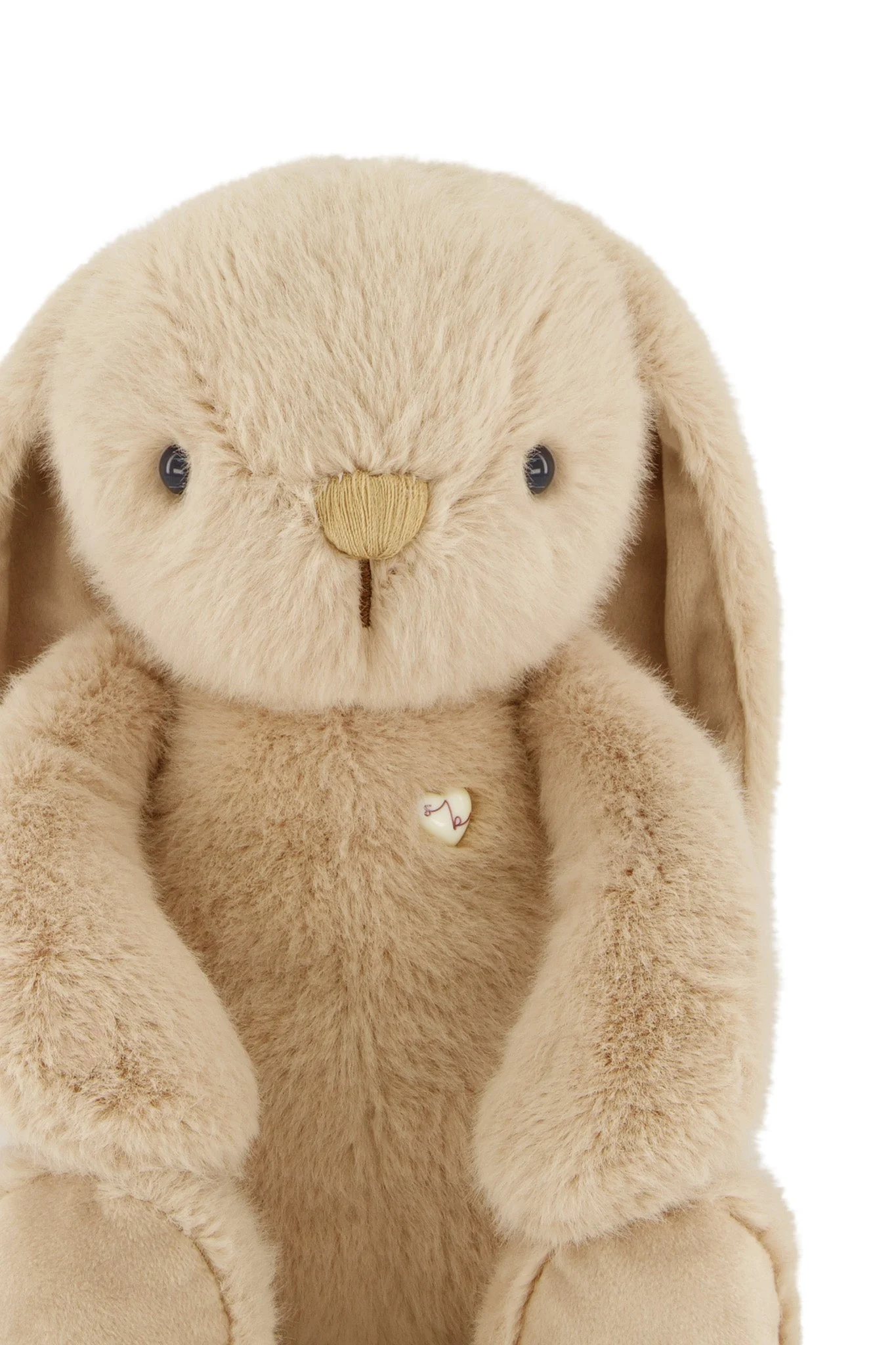 
                  
                    Beige plush bunny with a heart tag on a white background.
                  
                