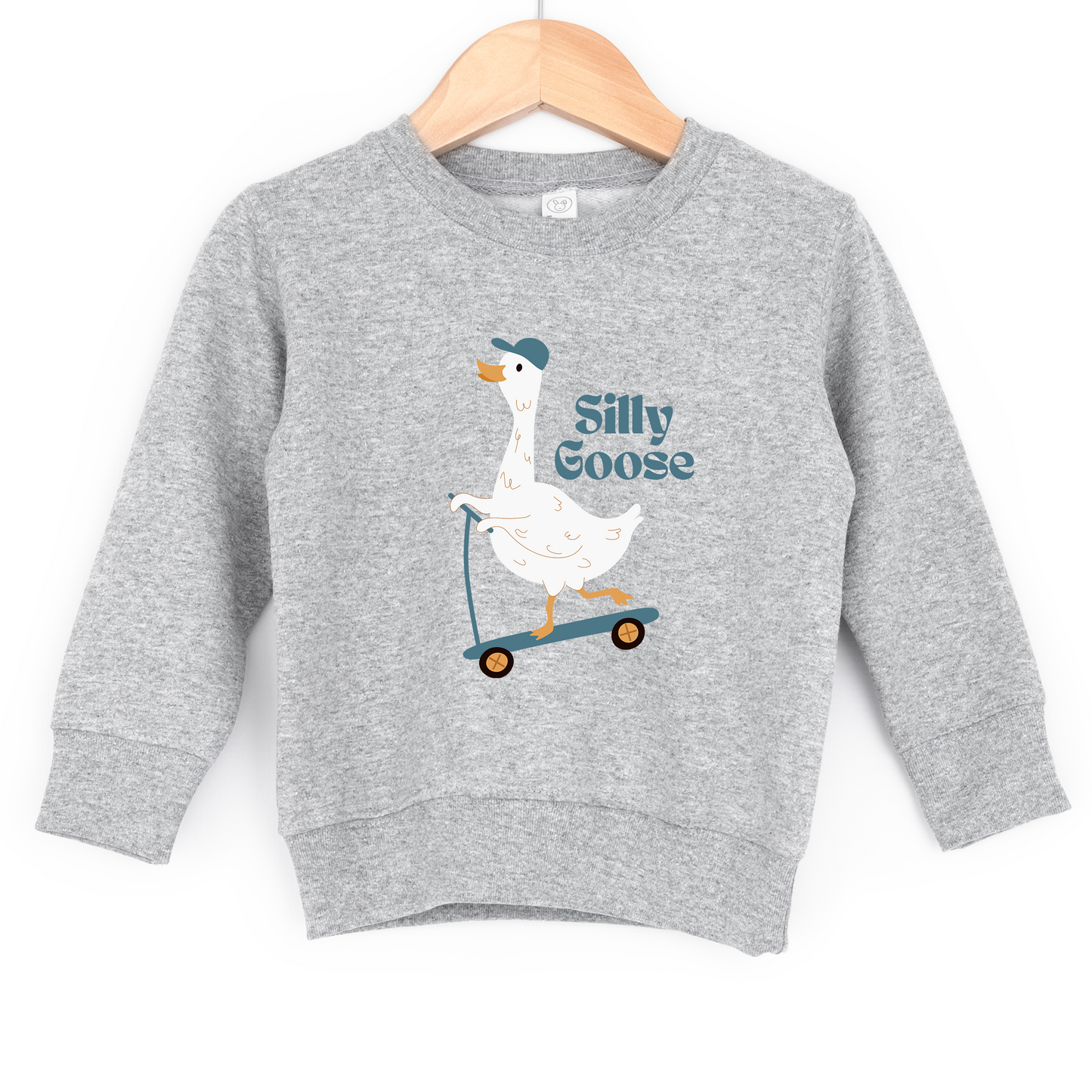 
                  
                    Gray sweatshirt with a cartoon goose on a scooter and 'Silly Goose' text, hanging on a wooden hanger.
                  
                