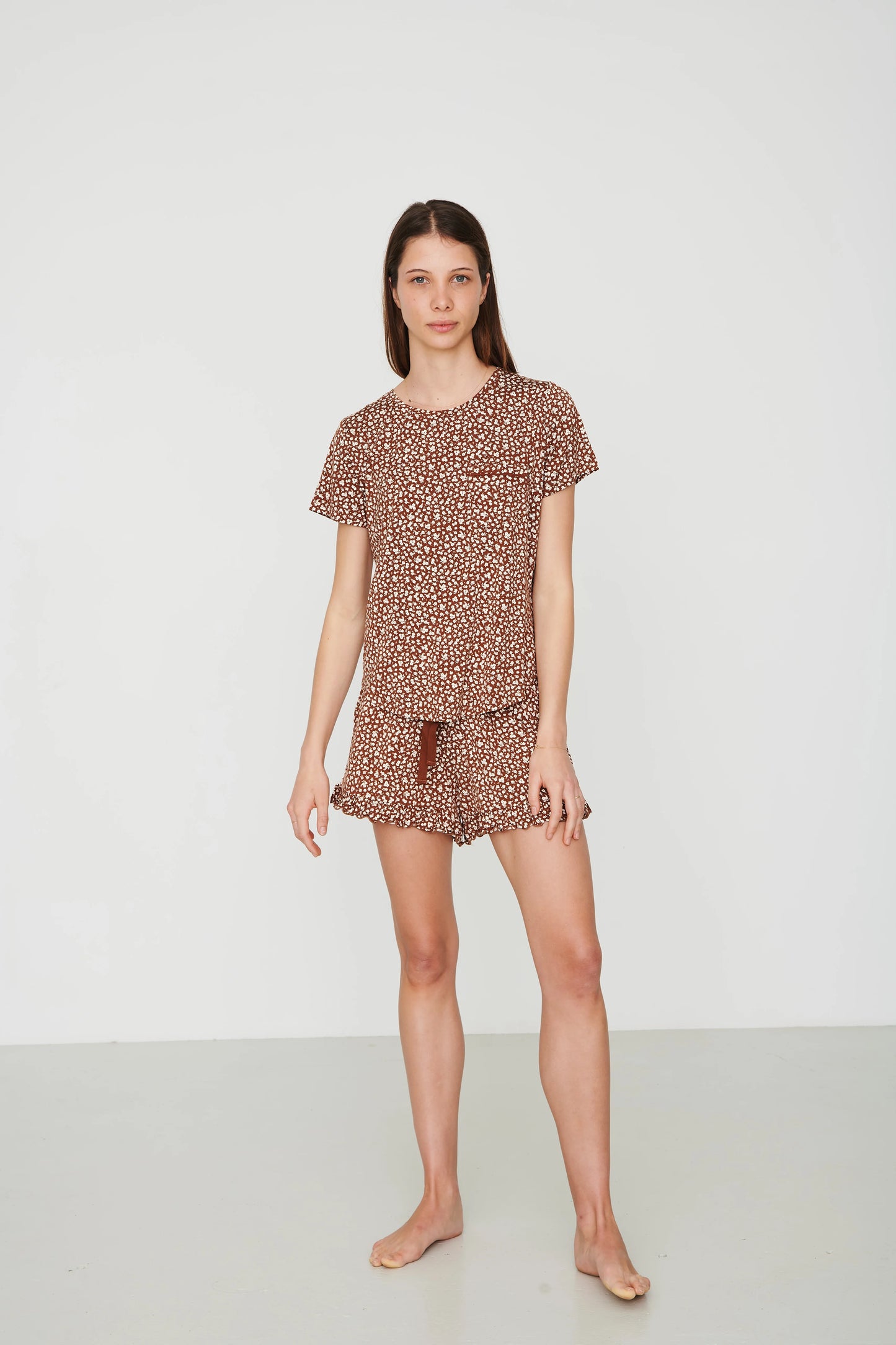 
                  
                    Person in shorts pajama set with a plain white background. 
                  
                