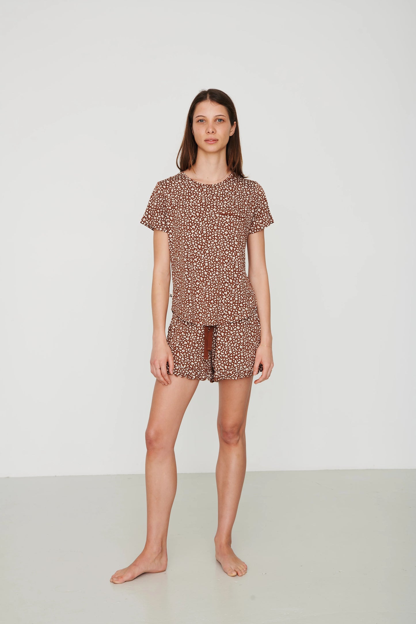
                  
                    Person in shorts pajama set with plain white background. 
                  
                