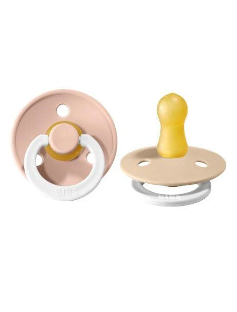 Two baby pacifiers in a blush colour on a white background
