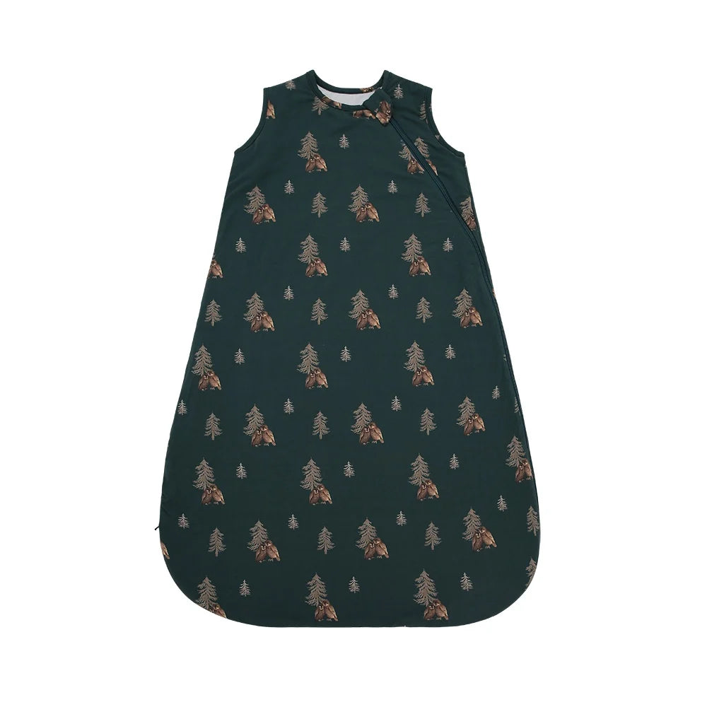 Dark green sleep sack with a pine tree and owl print against a white background. 