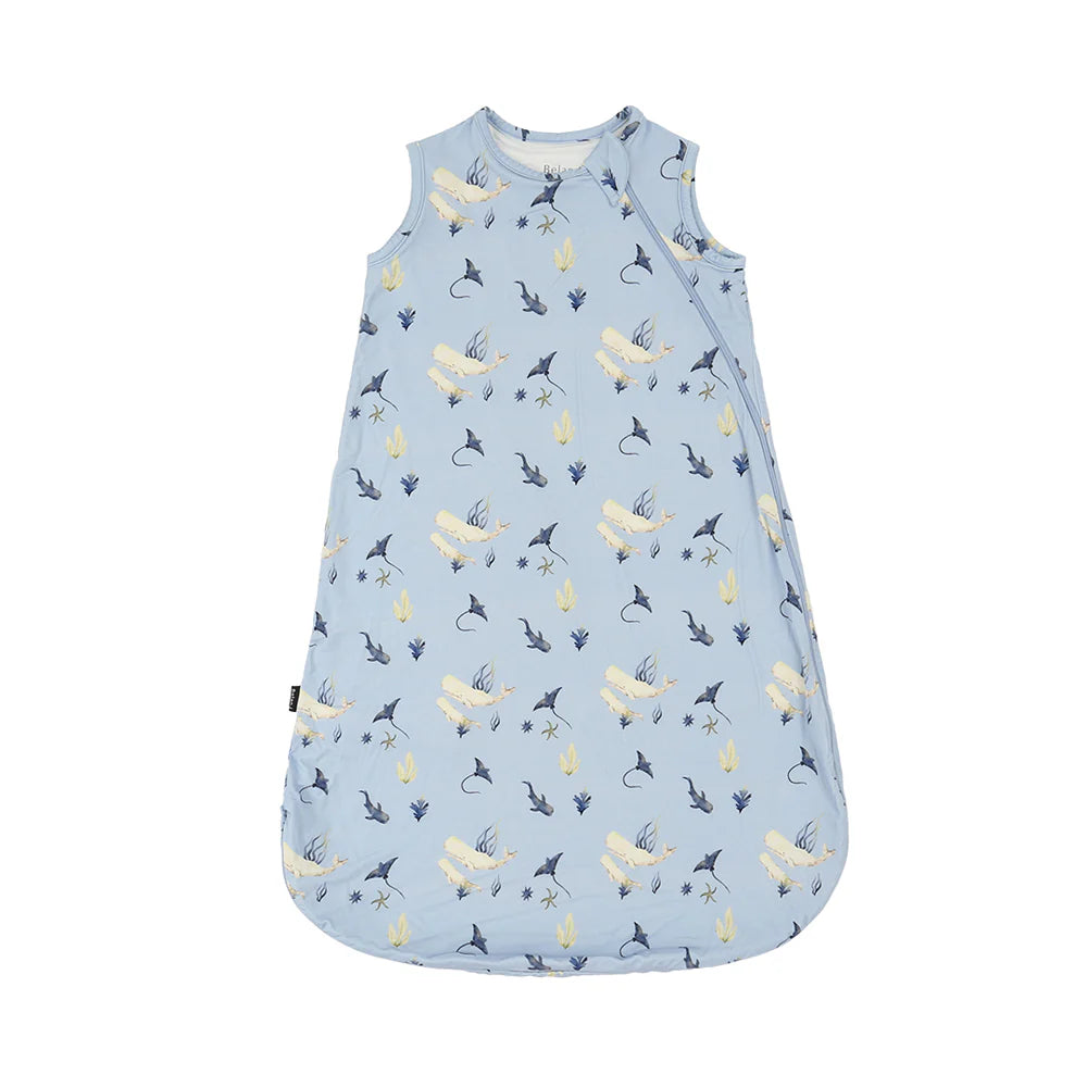 
                  
                    Blue sleep sack with a whale print and a white background. 
                  
                