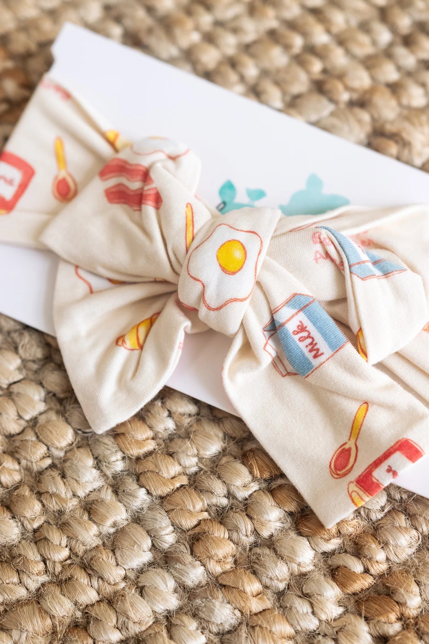 
                  
                    Headband with a breakfast foods print on a textured background. 
                  
                