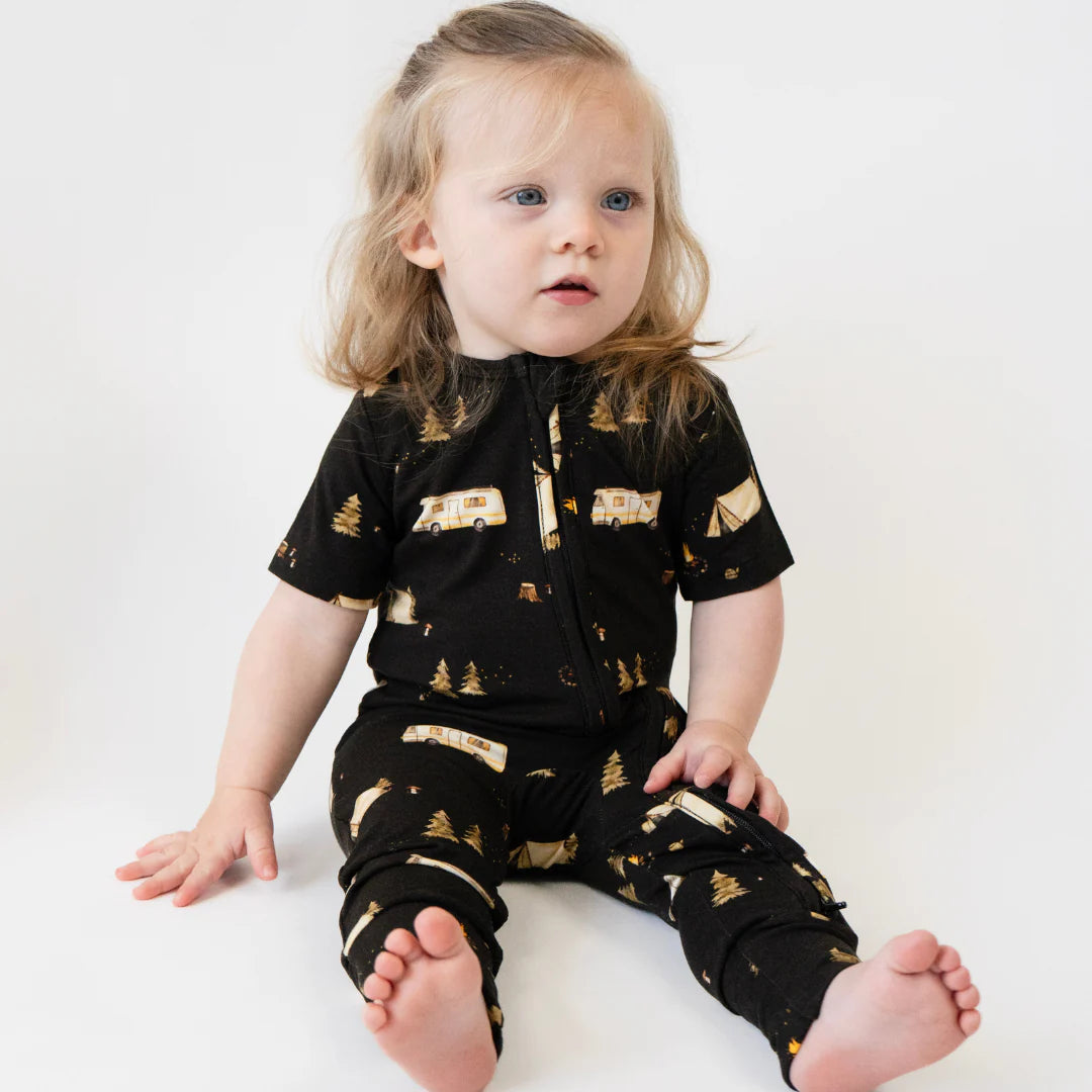 
                  
                    Child wearing a brown short sleeve zipper romper with white background.
                  
                