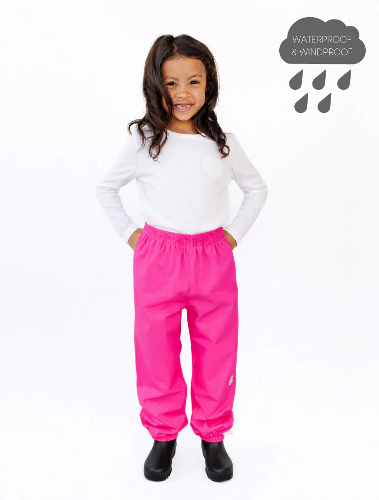 
                  
                    Child wearing pink waterproof pants on a white background
                  
                
