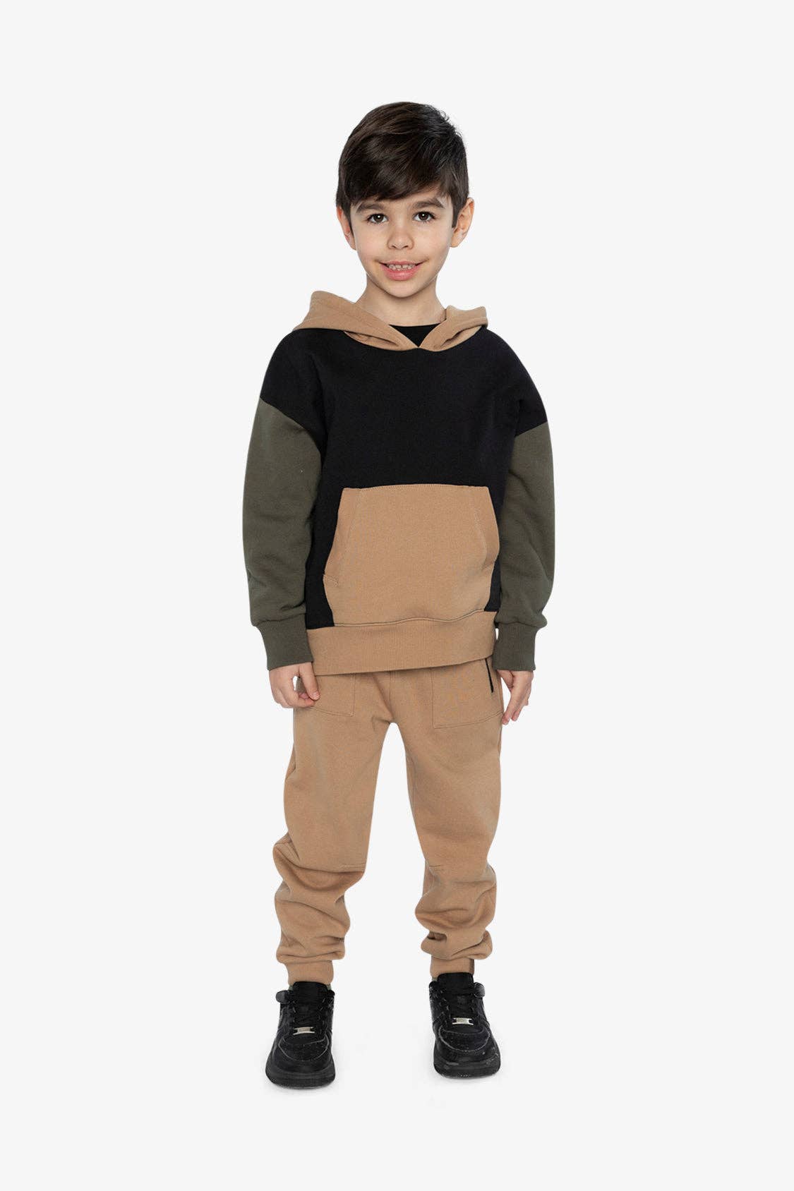 
                  
                    Child wearing a black and beige hoodie with matching pants on a white background.
                  
                