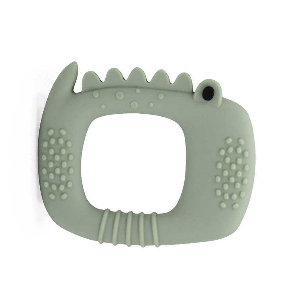 Sage green silicone teething ring with textured surface on a white background