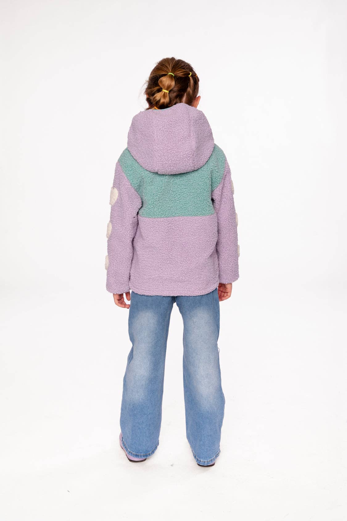 
                  
                    Person wearing a two-tone jacket with a hood on a white background.
                  
                