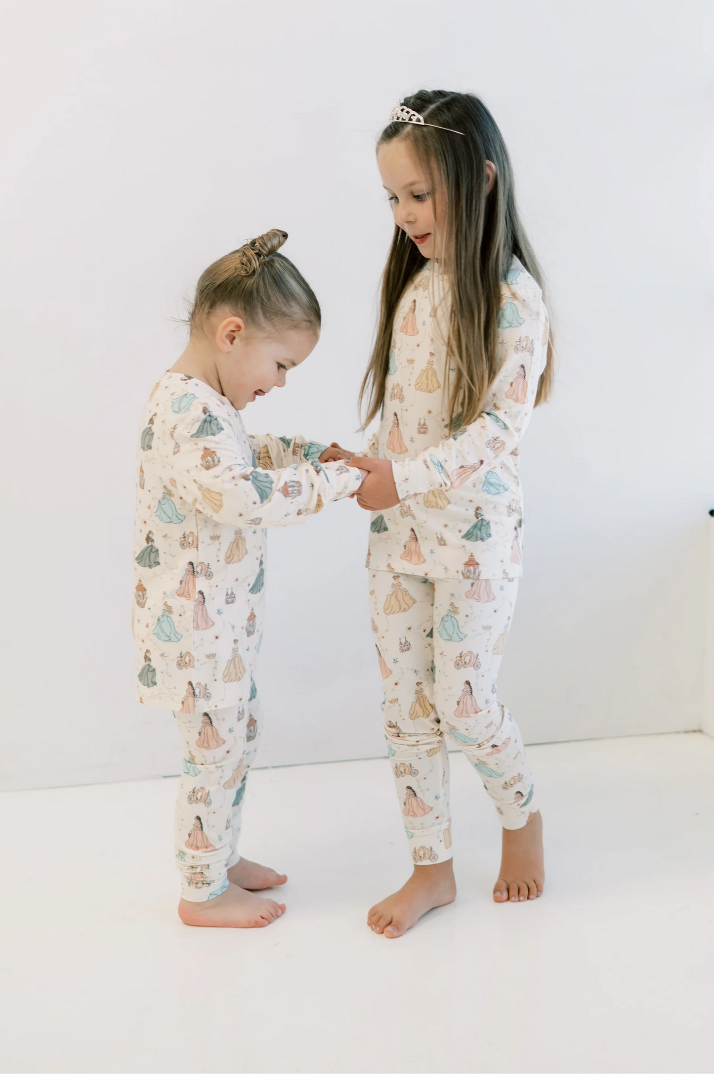 
                  
                    Two children playing in bamboo lounge sets with princess prints against a white background. 
                  
                